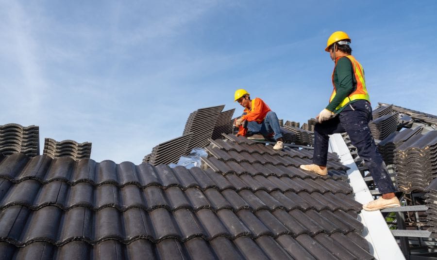 Roof maintenance professional inspecting shingles